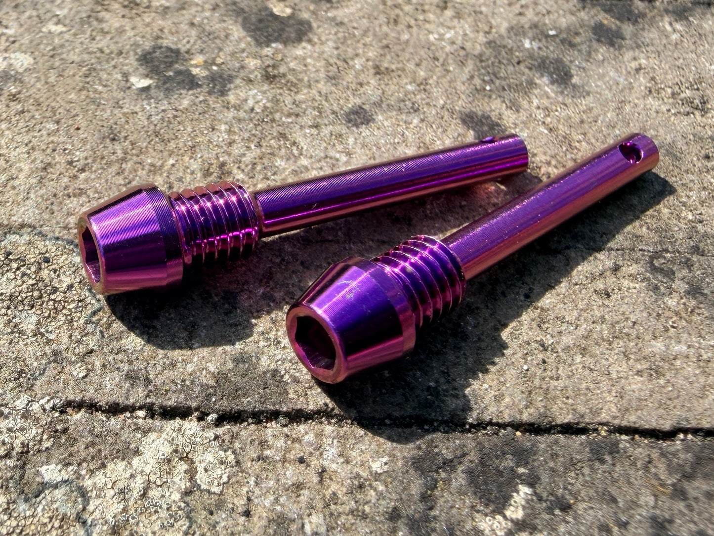 purple Hope brake pad retention pins in CNC machined titanium