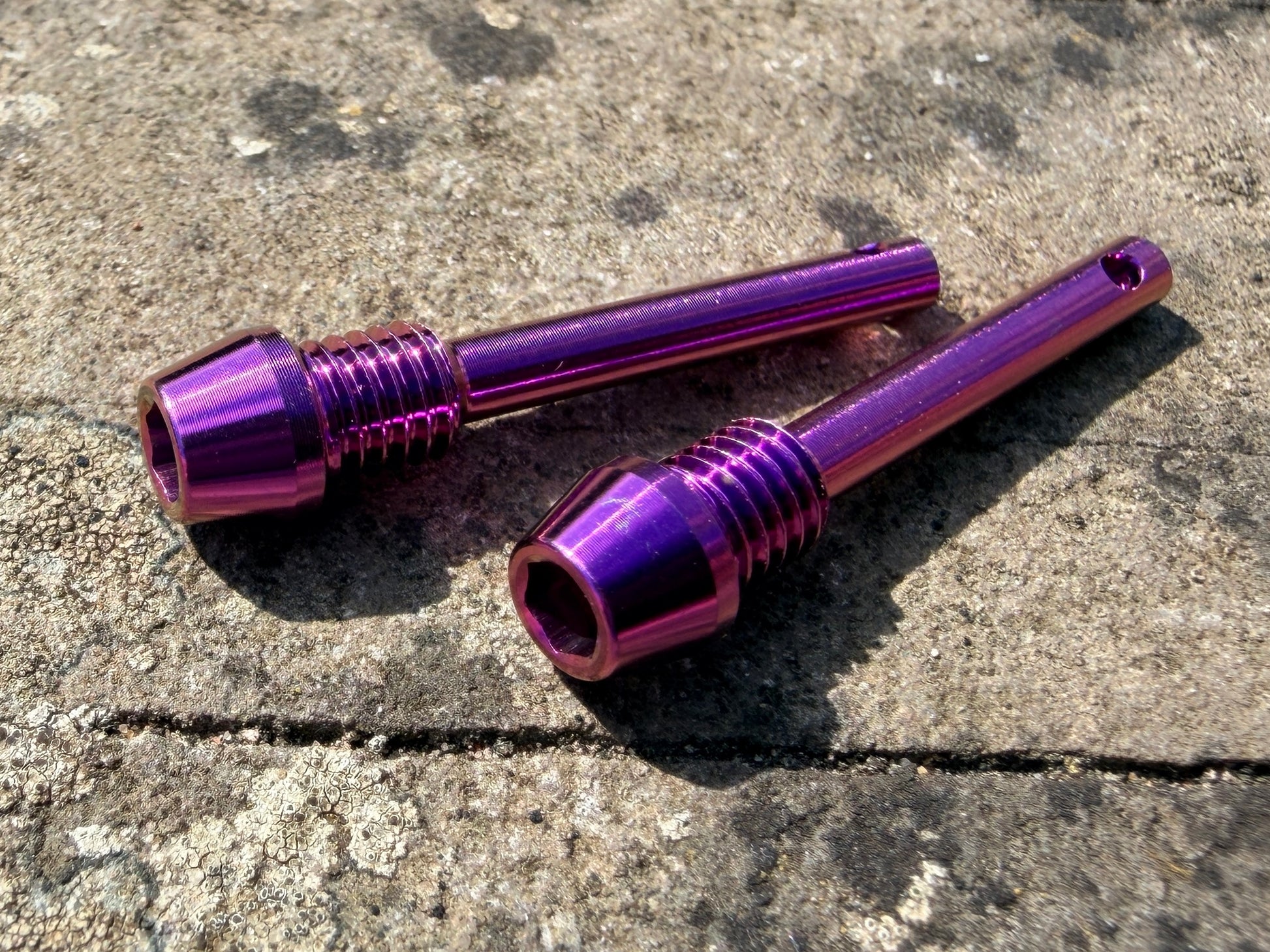 purple Hope brake pad retention pins in CNC machined titanium