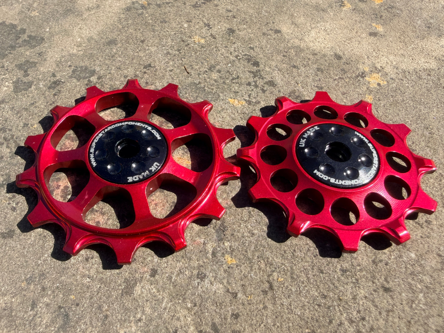 A pair of red jockey wheels with sealed bearings, designed for use with SRAM EAGLE XX rear derailleurs.