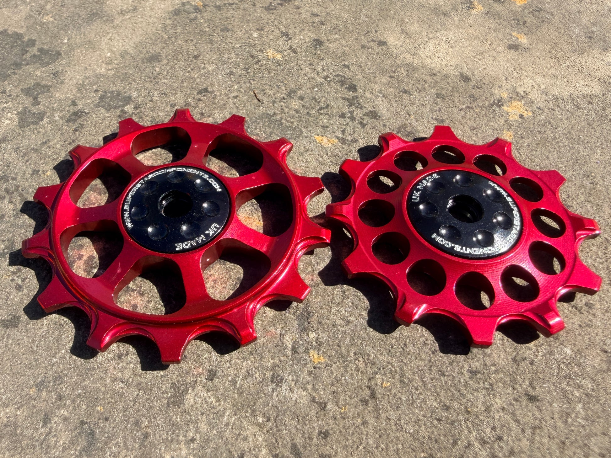 A pair of red jockey wheels with sealed bearings, designed for use with SRAM EAGLE XX rear derailleurs.