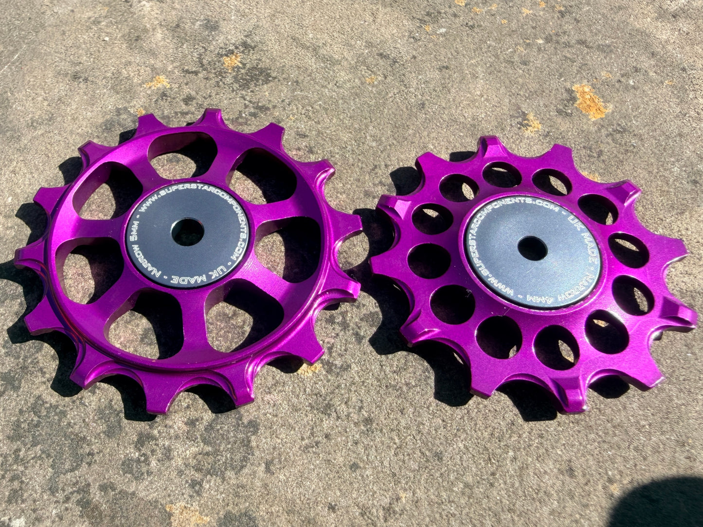 A pair of purple jockey wheels with sealed bearings, designed for use with SRAM AXS rear derailleurs.