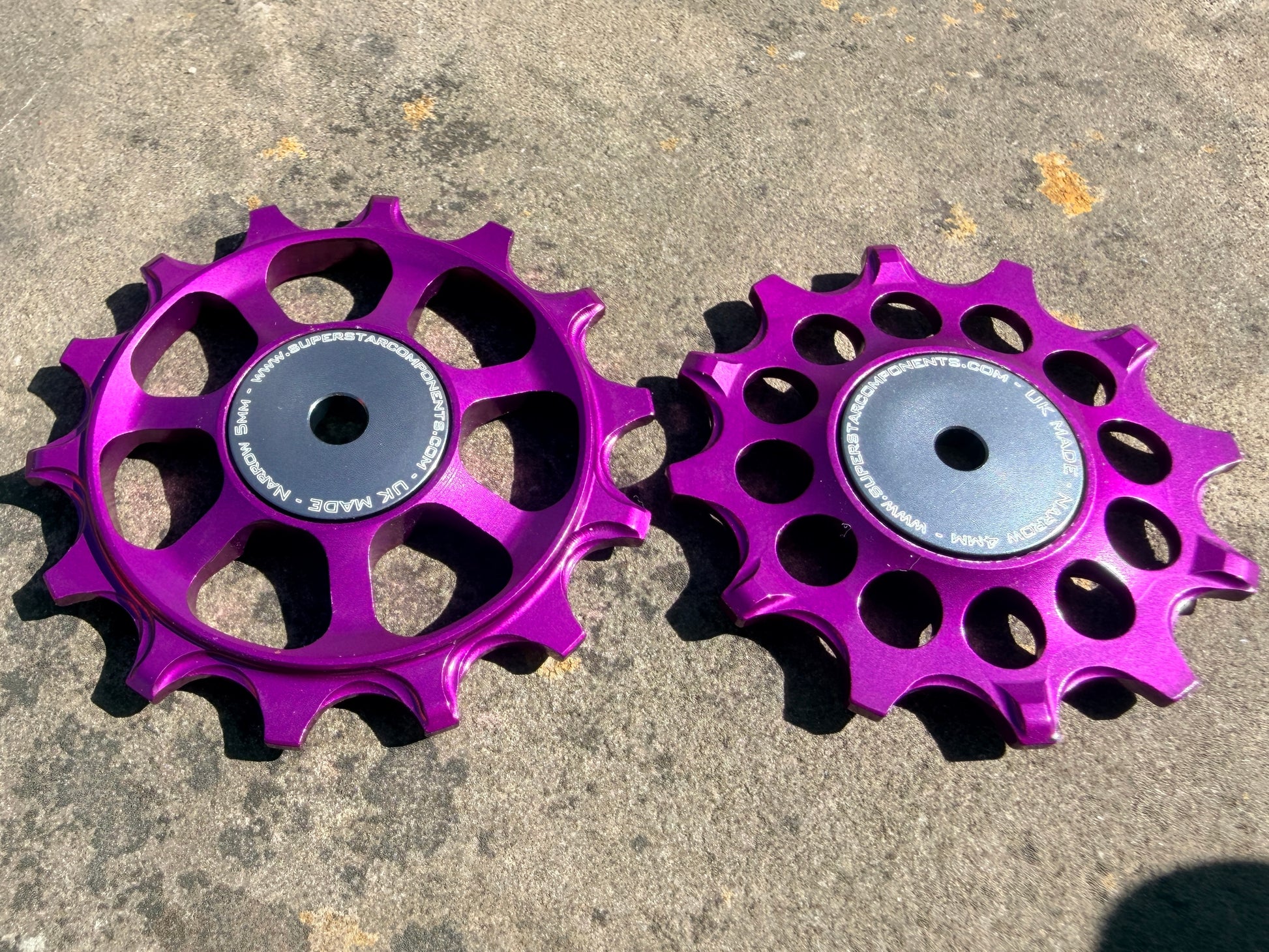 A pair of purple jockey wheels with sealed bearings, designed for use with SRAM AXS rear derailleurs.