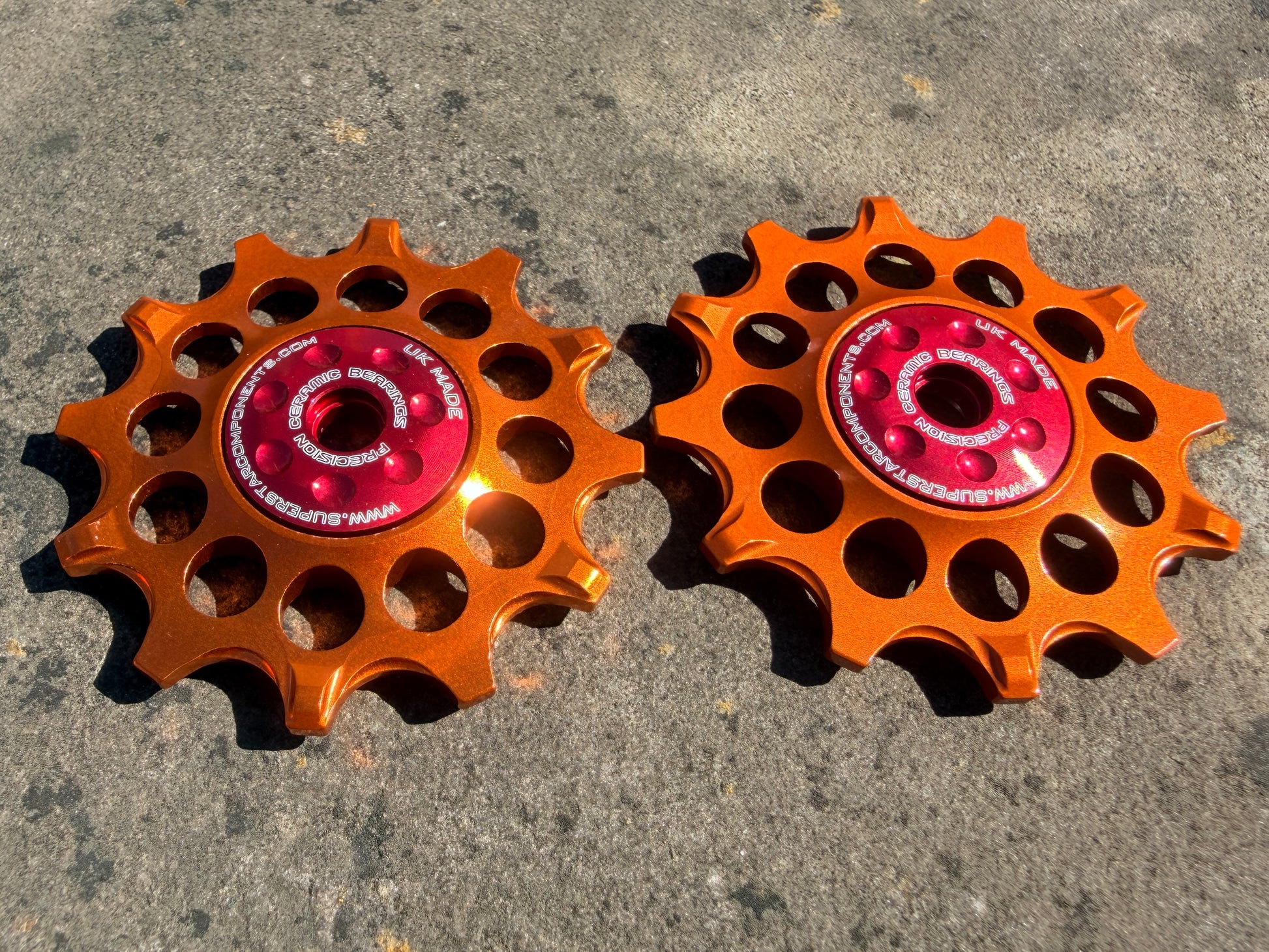 orange 12T jockey wheels with sealed ceramic bearings, designed for use with SRAM rear derailleurs.