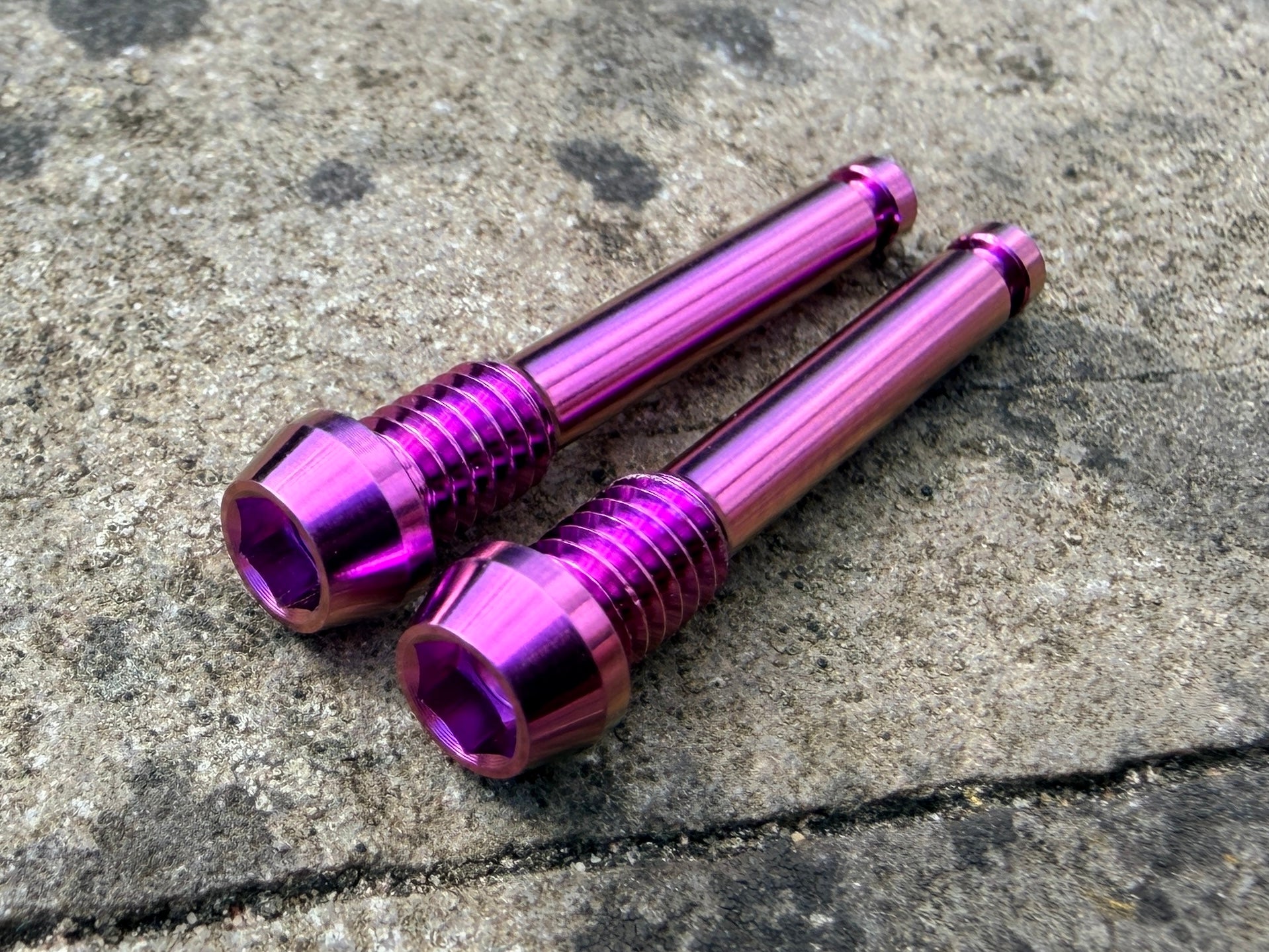 purple SRAM brake pad retention pins in CNC machined titanium