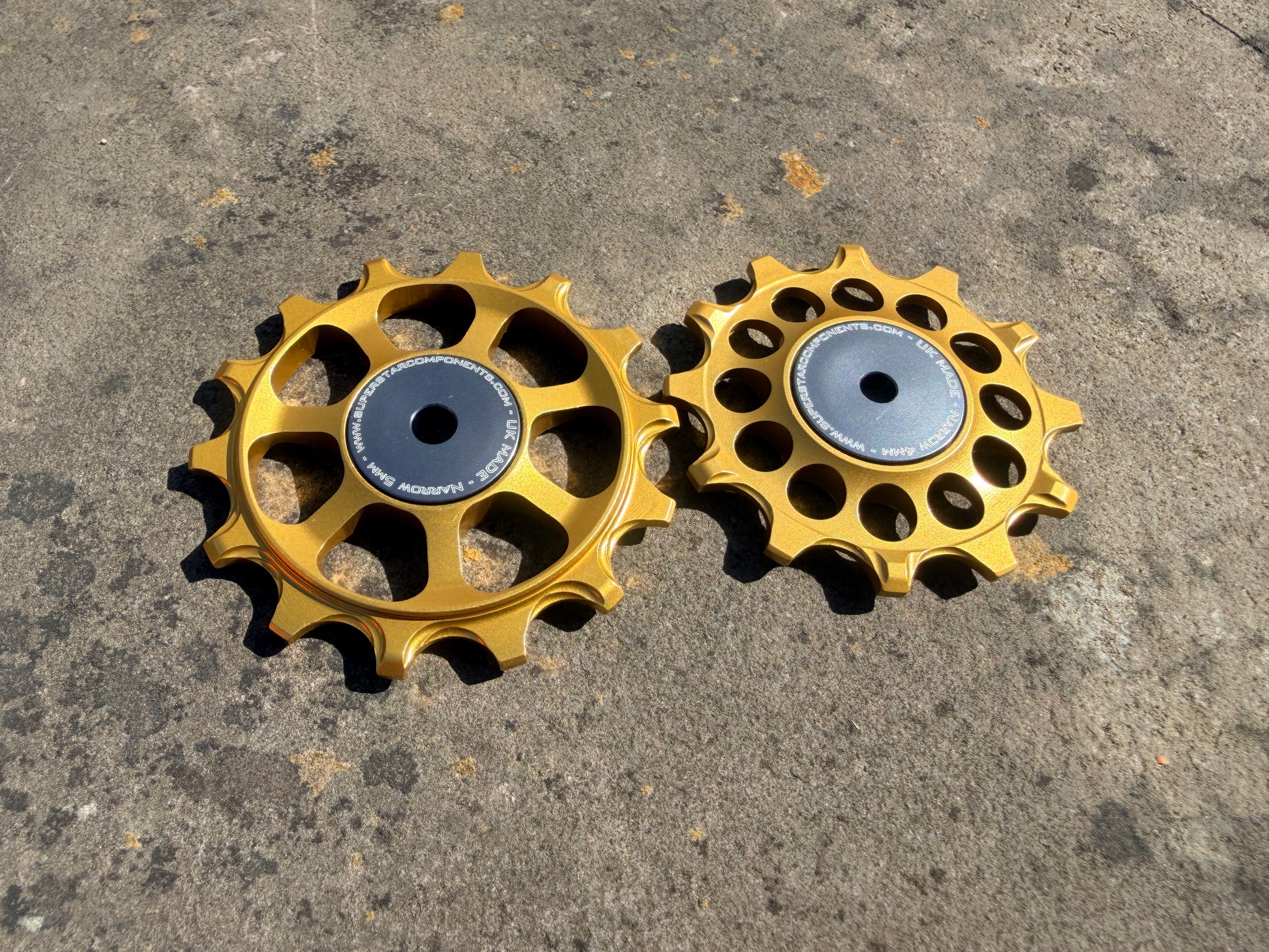 A pair of gold jockey wheels with sealed bearings, designed for use with SRAM AXS rear derailleurs.