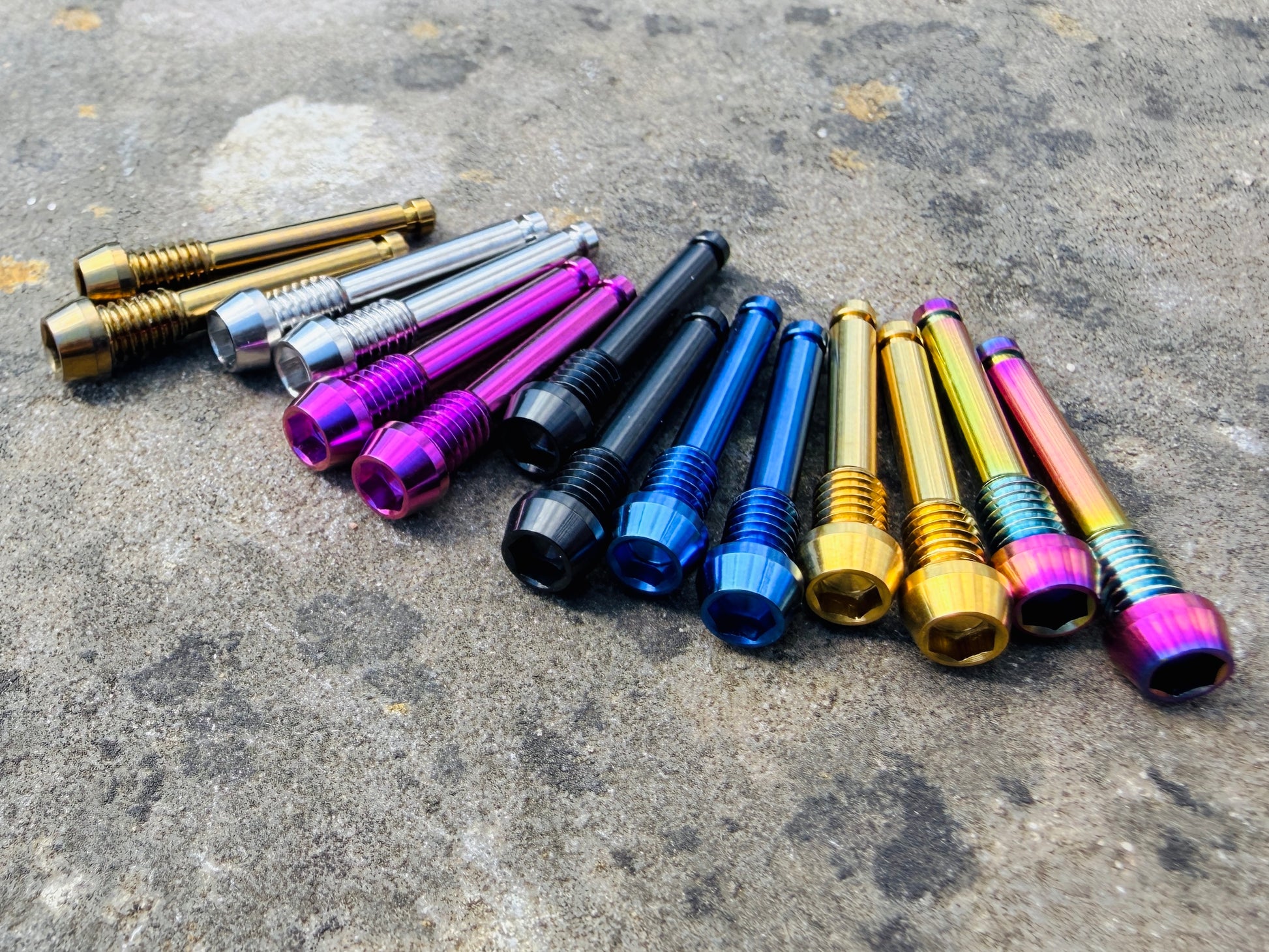 Colourful SRAM brake pad retention pins in CNC machined titanium