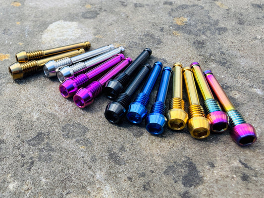 Colourful SRAM brake pad retention pins in CNC machined titanium