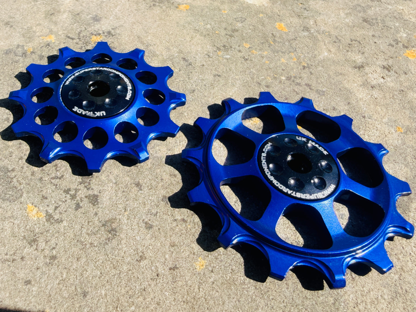 A pair of blue jockey wheels with visible bearing shields, designed for use with SRAM EAGLE rear derailleurs.