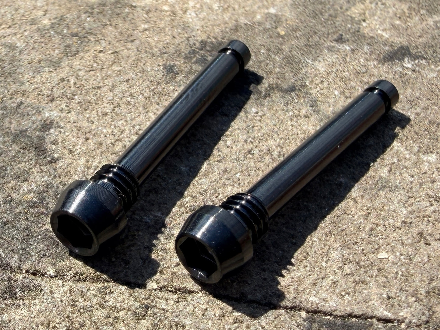 Black Magura brake pad retention pins in cnc machined titanium