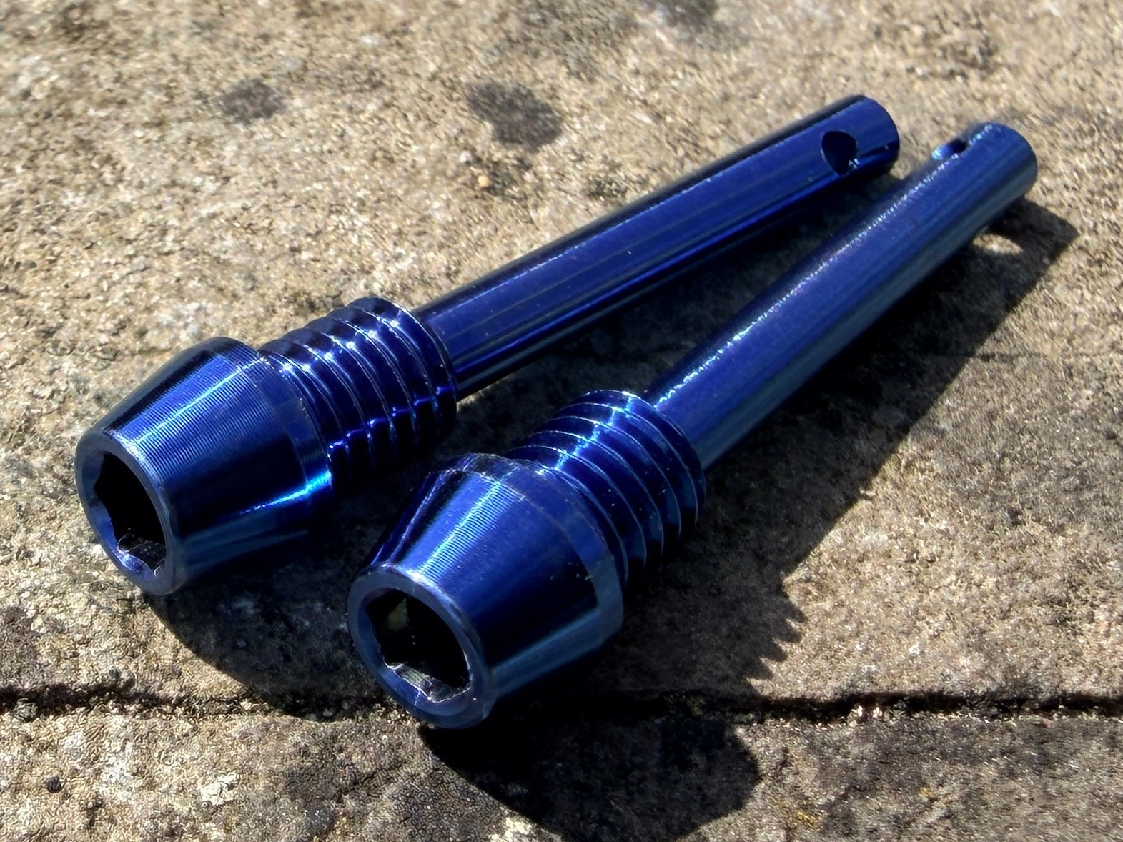 blue Hope brake pad retention pins in CNC machined titanium
