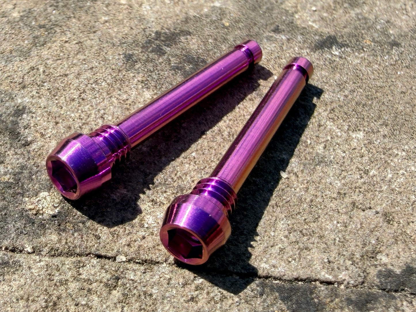 Purple Magura brake pad retention pins in cnc machined titanium