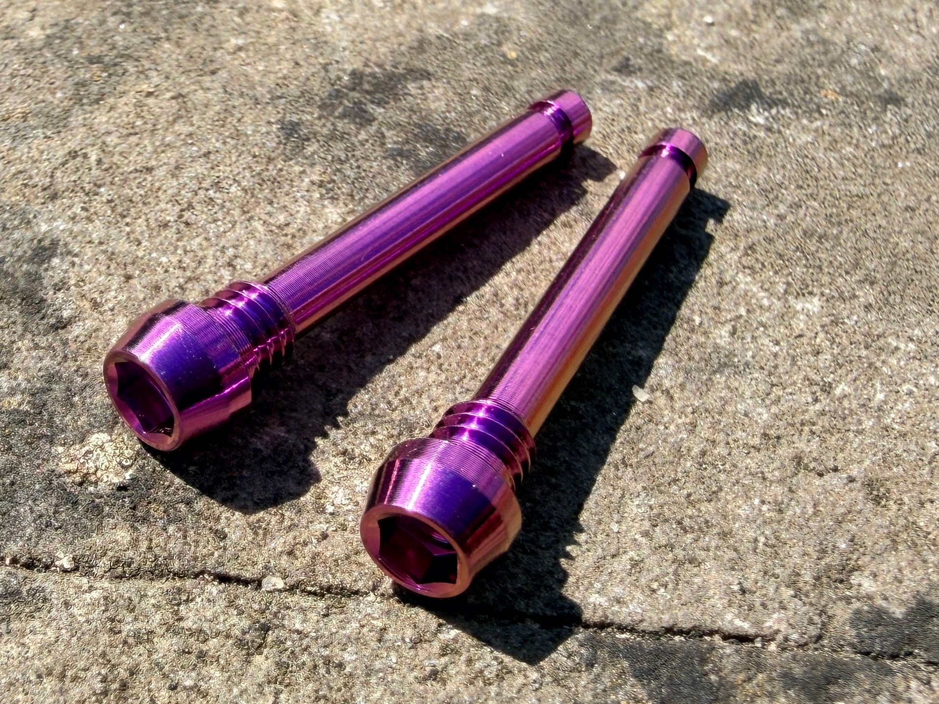 Purple Magura brake pad retention pins in cnc machined titanium