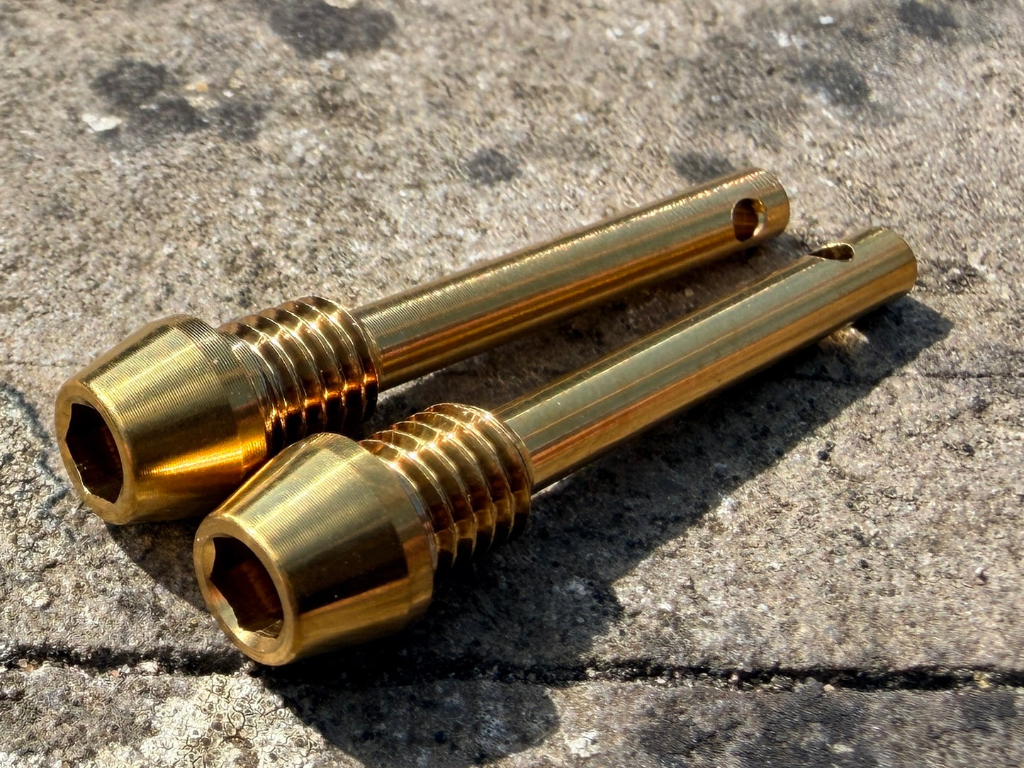 gold Hope brake pad retention pins in CNC machined titanium
