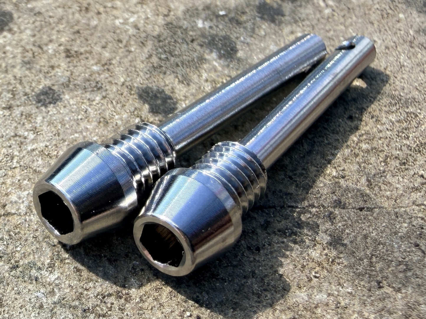silver Hope brake pad retention pins in CNC machined titanium