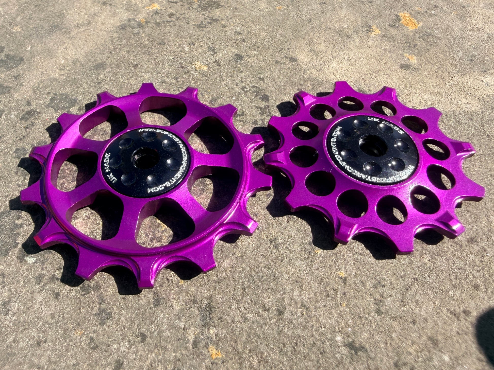 A pair of purple jockey wheels with sealed bearings, designed for use with SRAM EAGLE NX rear derailleurs.