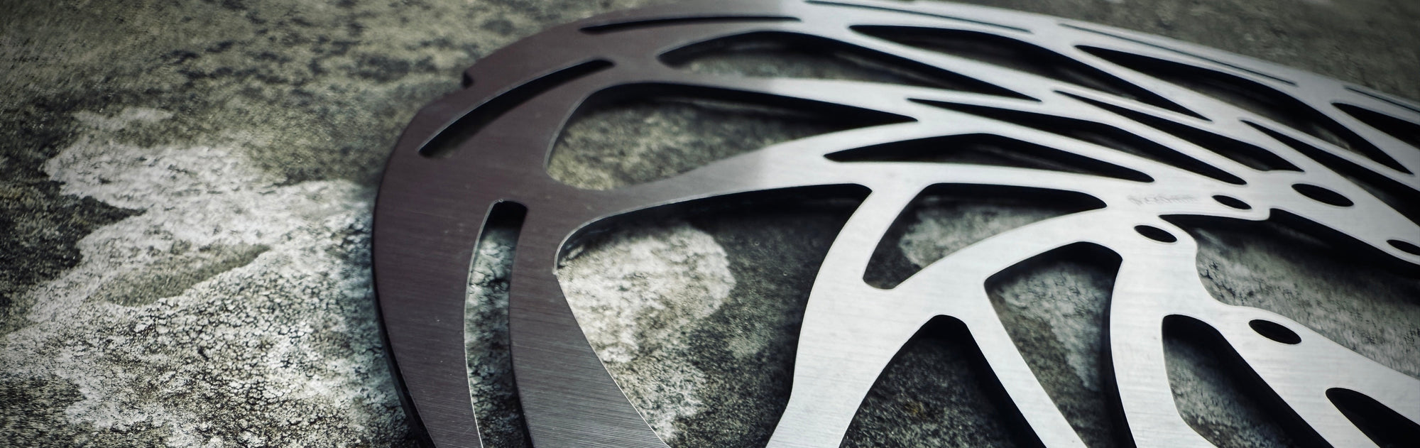 2.3mm ultra thick 6 bolt 
Metallic disc brake rotor on a textured surface