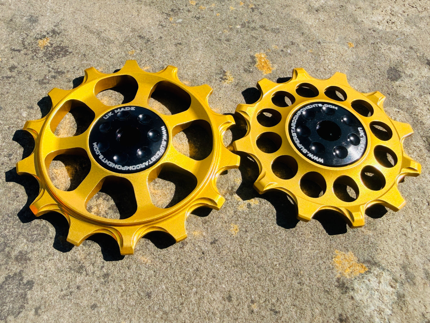 A pair of gold jockey wheels with sealed bearings, designed for use with SRAM EAGLE rear derailleurs.