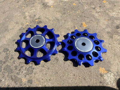 A pair of blue jockey wheels with sealed bearings, designed for use with SRAM AXS rear derailleurs.