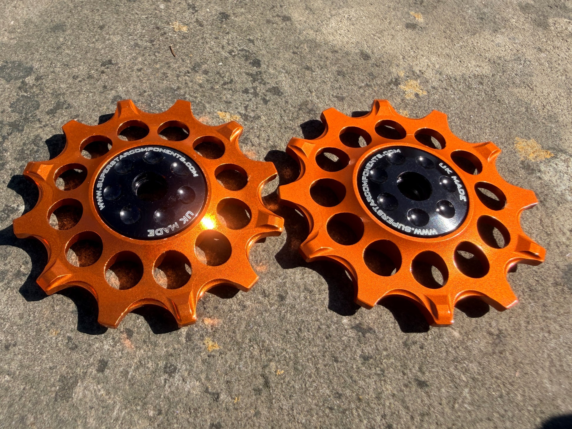 orange 12T jockey wheels with sealed bearings, designed for use with SRAM rear derailleurs.